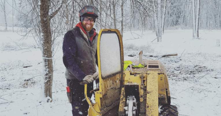 ISA Certified Arborist preparing soil after stump grinding in Milwaukee