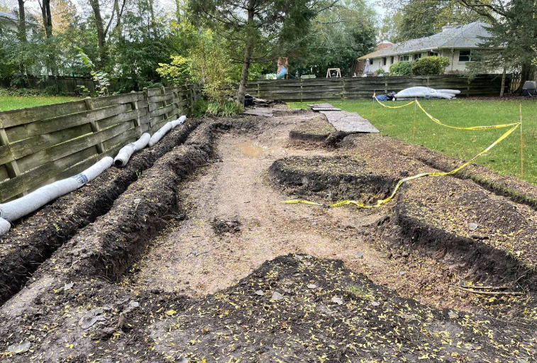 Newly installed perennial planting beds with fresh mulch in a Bayside estate.